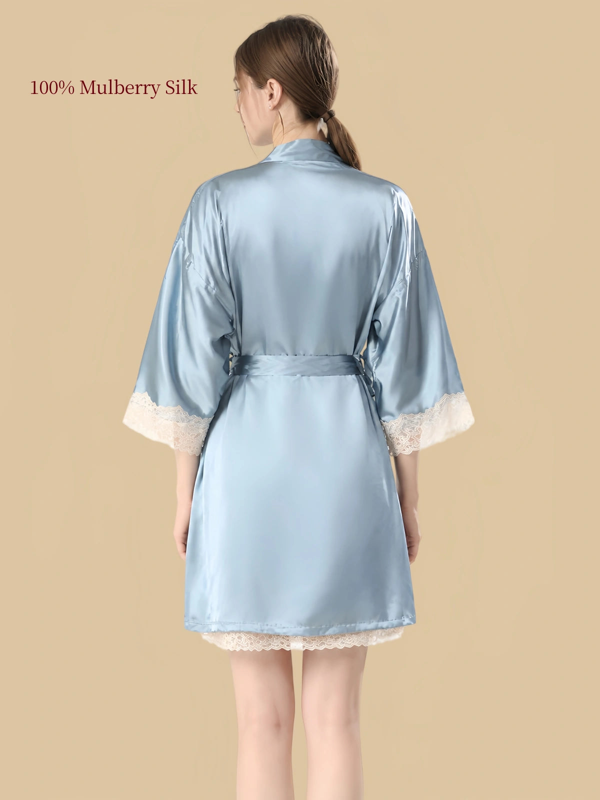 Back view of Clear Sky Blue silk robe featuring a relaxed silhouette, waist tie and ivory floral lace sleeve cuffs.