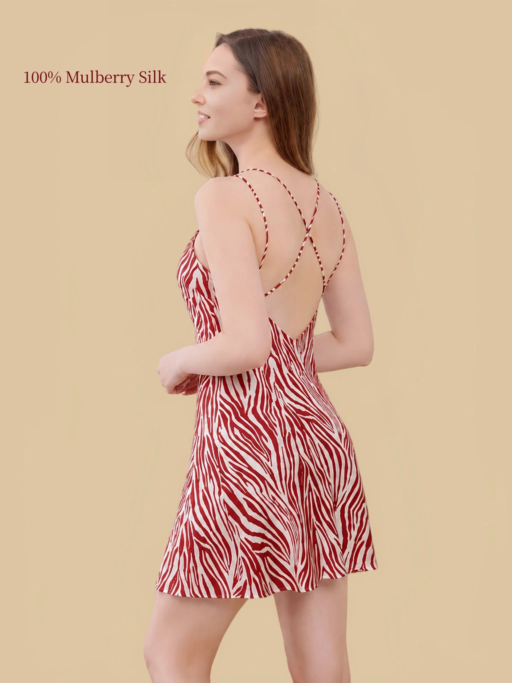 Side-back view of red-and-white zebra print silk nightdress showing crossed shoulder straps and a low V-shaped back.