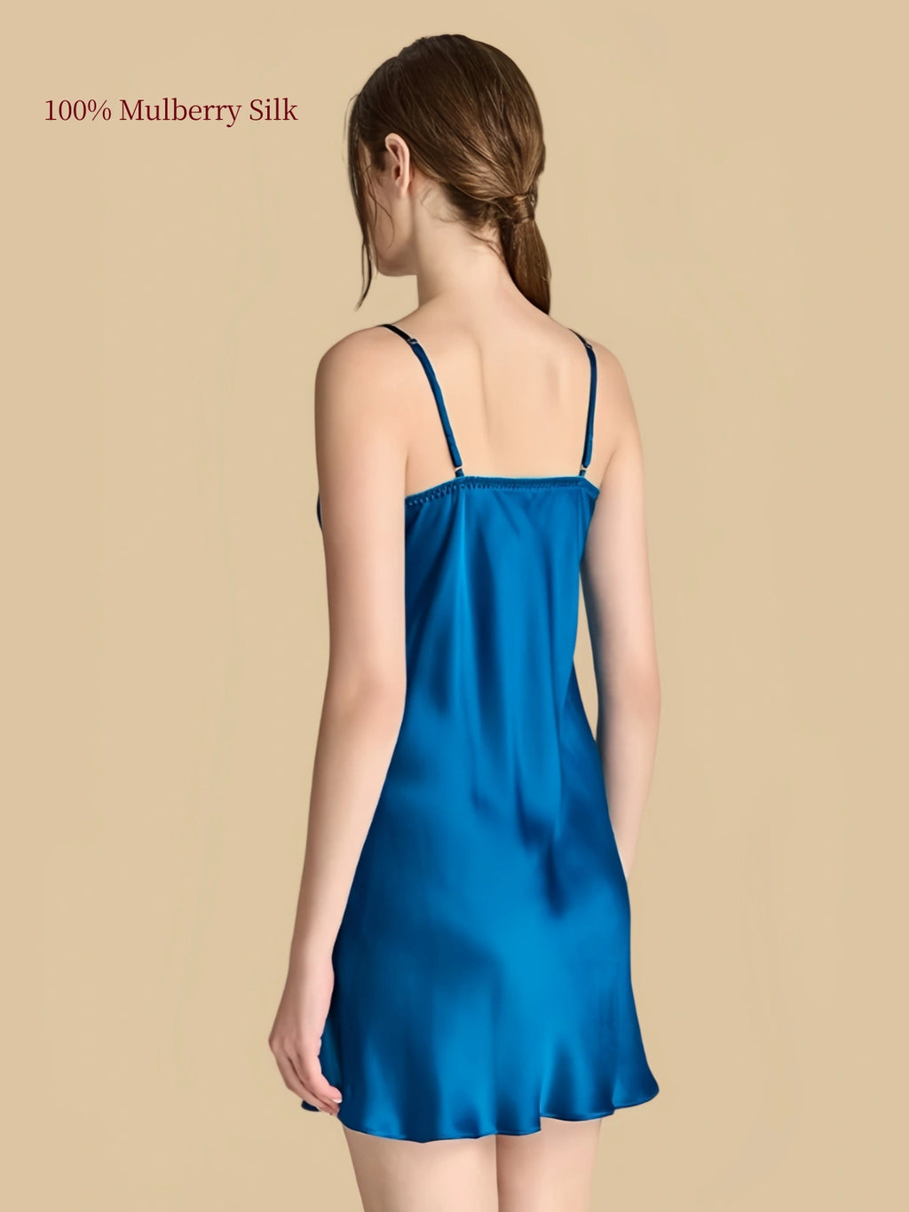Back view of Electric Blue silk cami dress showing adjustable straight shoulder straps and softly flared short hem.