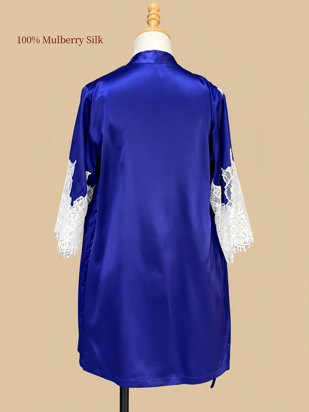 Back view of Royal Blue mulberry silk robe displayed on a dress form with white floral lace cuffs and smooth silk fabric.