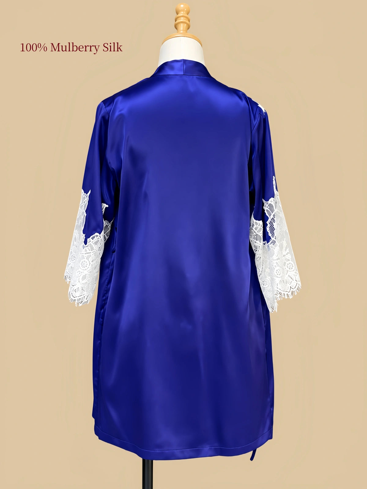 Back view of Royal Blue mulberry silk robe displayed on a dress form with white floral lace cuffs and smooth silk fabric.