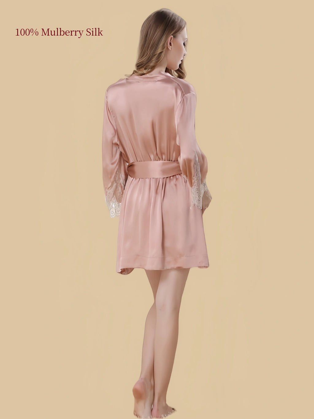 Back view of a skin-tone silk robe with a matching waist belt, flowing silhouette and lace sleeve cuffs.