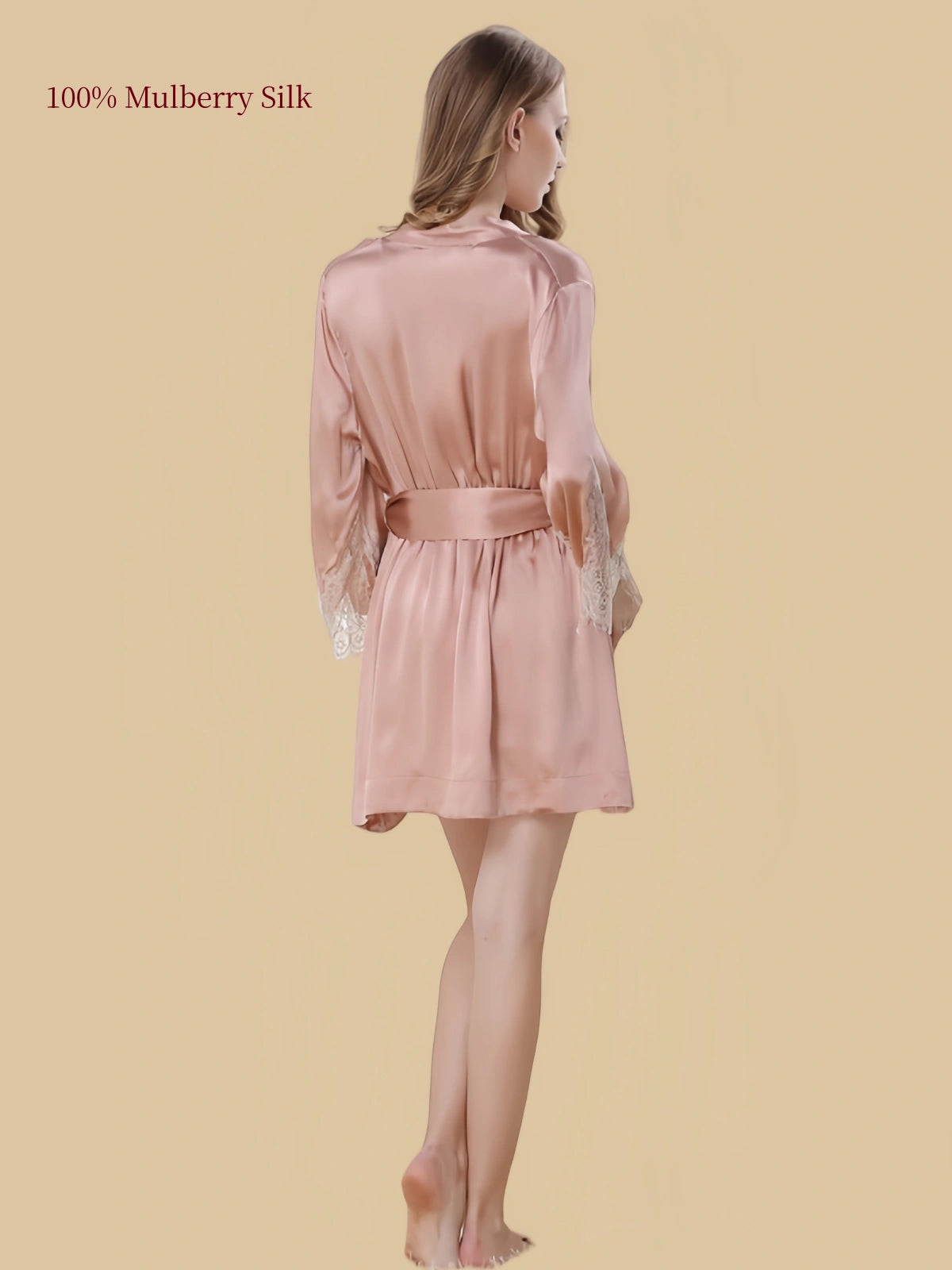 Back view of a skin-tone silk robe with a matching waist belt, flowing silhouette and lace sleeve cuffs.
