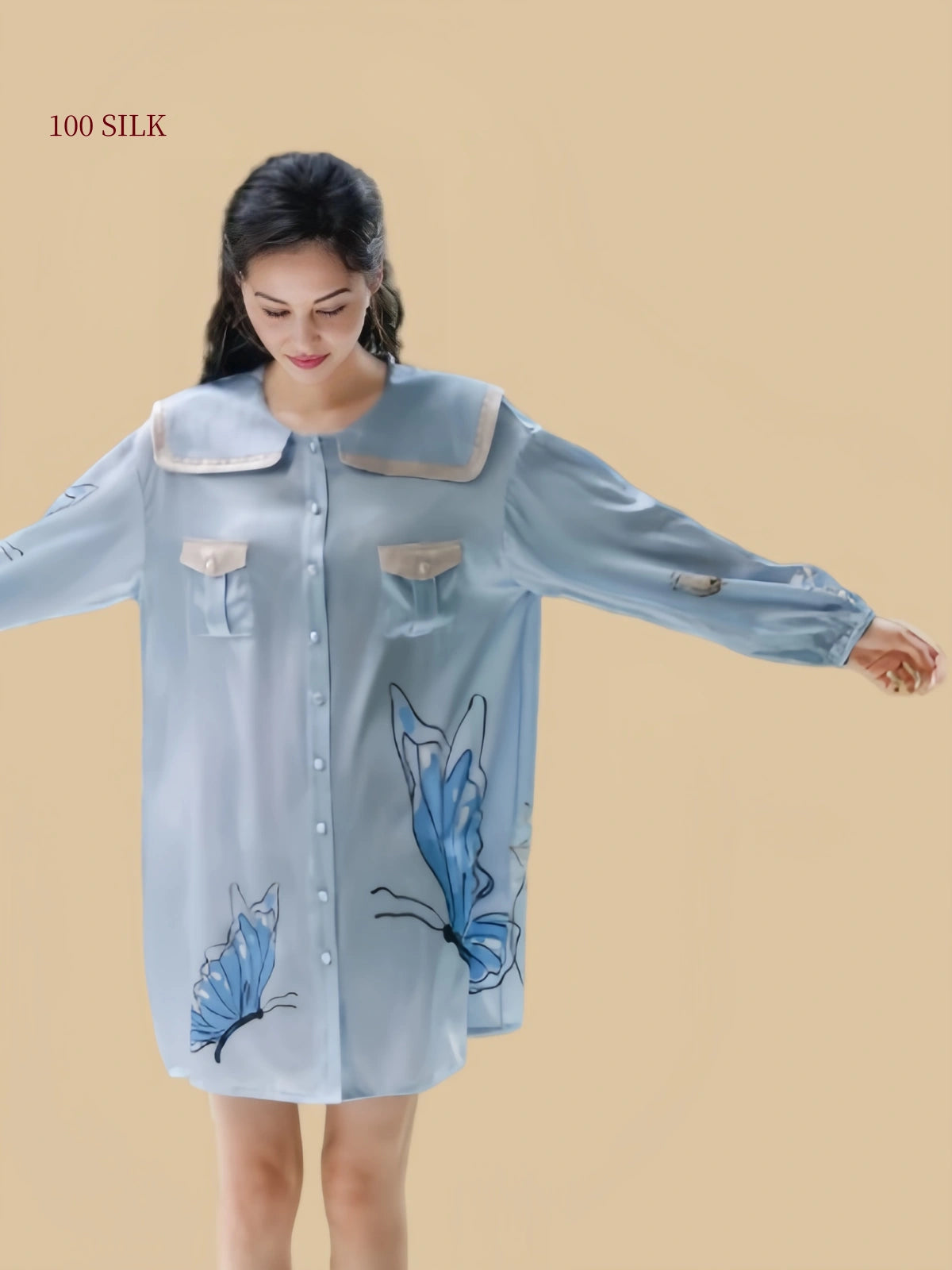 Full front view of a Dusty Blue mulberry silk sleep dress with long sleeves, contrast pockets and butterfly floral design