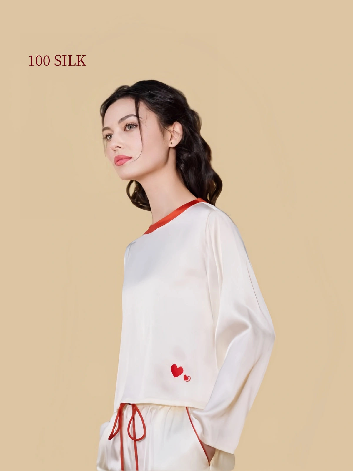 Close-up of ivory white 19mm silk pajamas showing the red neckline and double heart embroidery