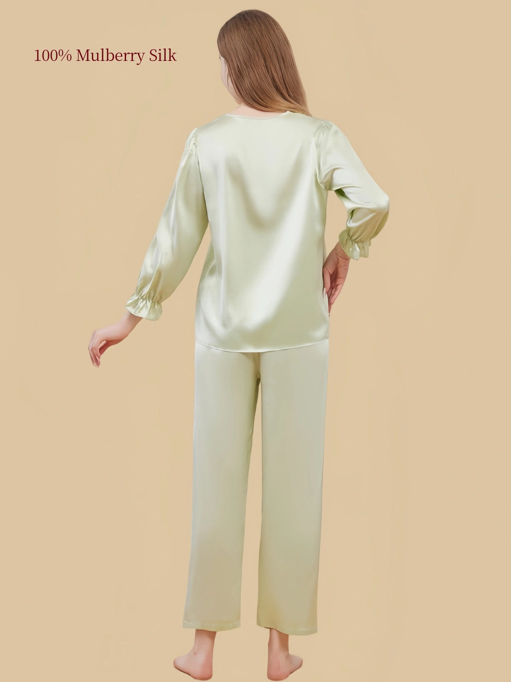 Back view of Silkgala Pale Pistachio Green silk pajama set showing the smooth pullover top, gathered sleeve cuffs and straight-leg pants.