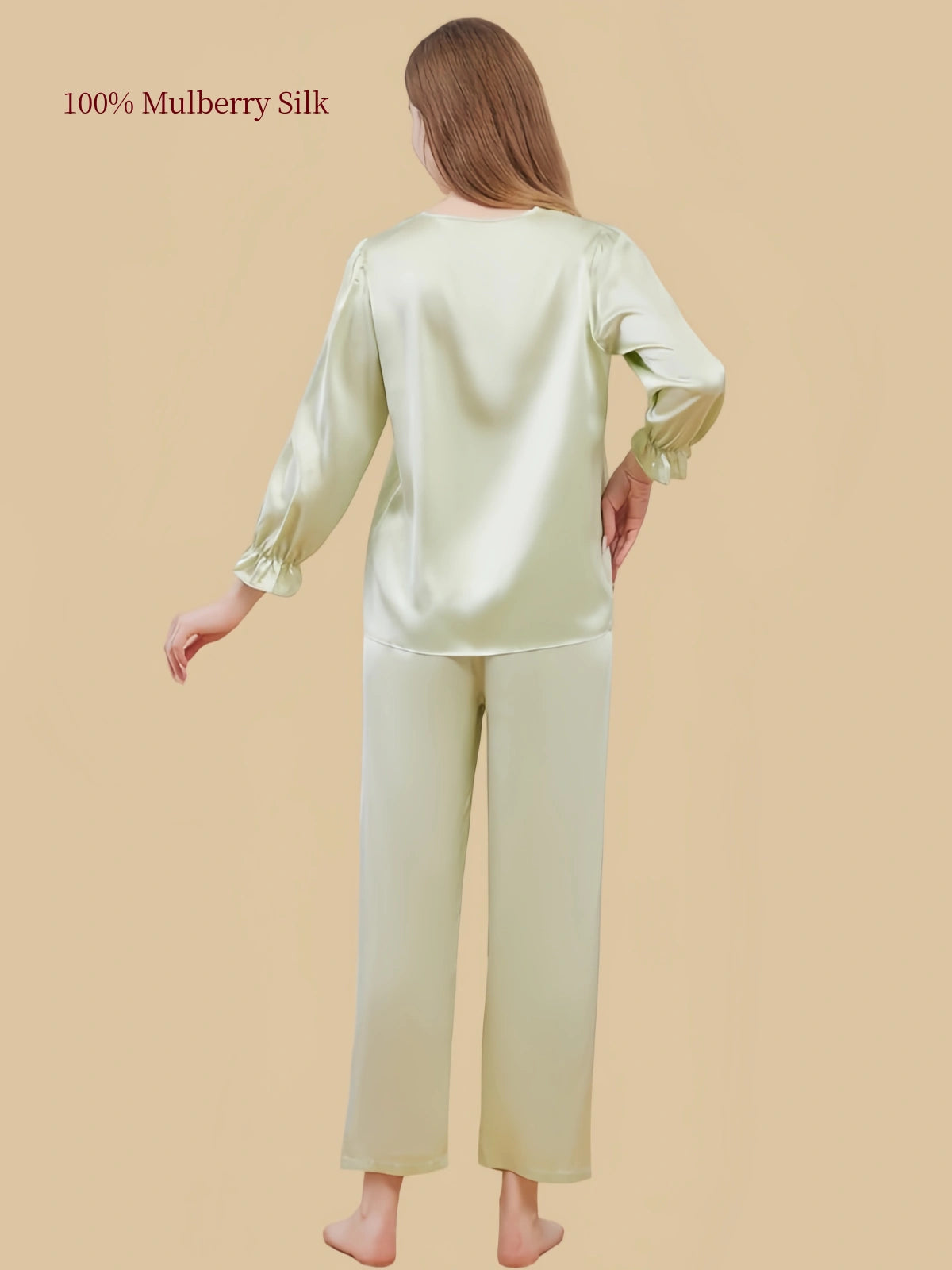 Back view of Silkgala Pale Pistachio Green silk pajama set showing the smooth pullover top, gathered sleeve cuffs and straight-leg pants.