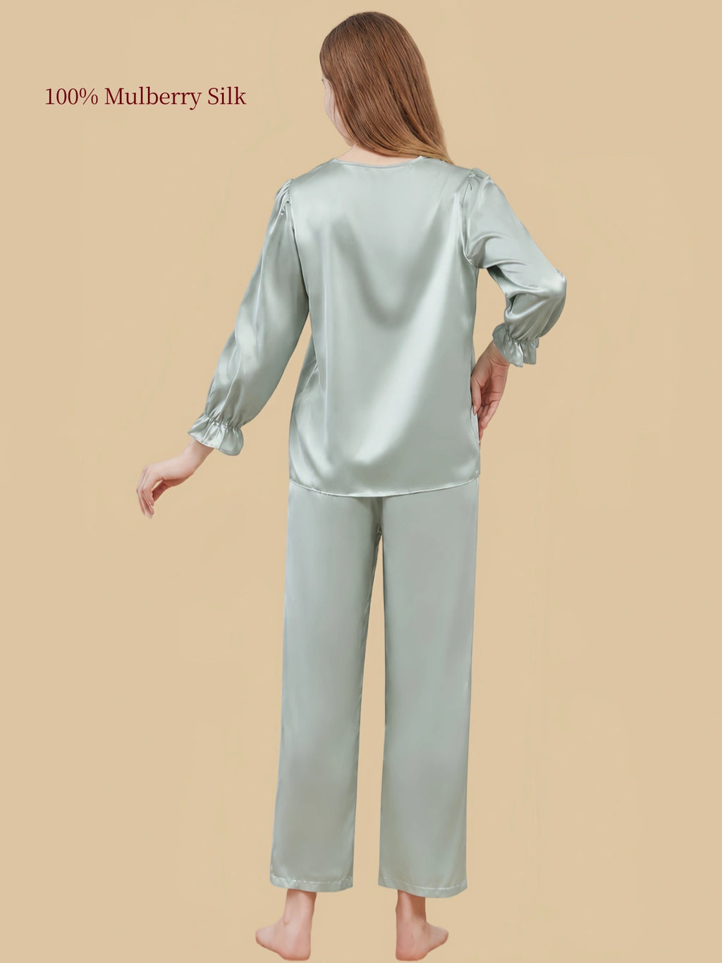 Rear view of Soft Sage Green silk sleepwear by Silkgala highlighting the loose-fitting top, softly gathered sleeves and matching pants.
