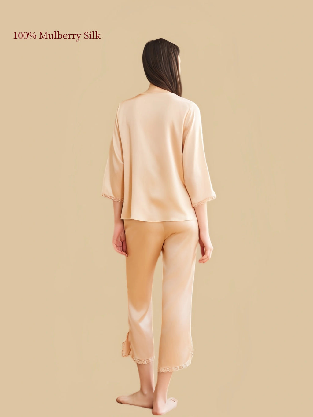 Rear view of Silkgala Wheat Gold silk pajama set highlighting the smooth drape of the top, three-quarter sleeves and calf-length pants with lace-trimmed hems.