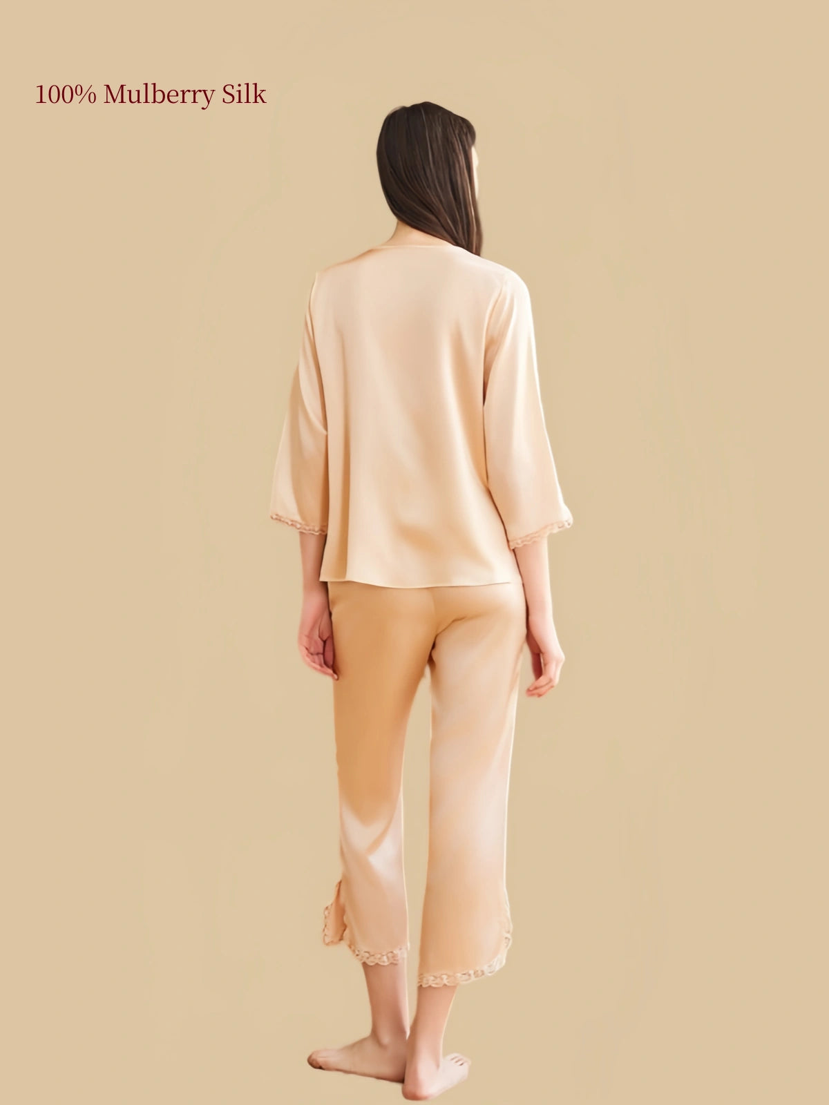Rear view of Silkgala Wheat Gold silk pajama set highlighting the smooth drape of the top, three-quarter sleeves and calf-length pants with lace-trimmed hems.
